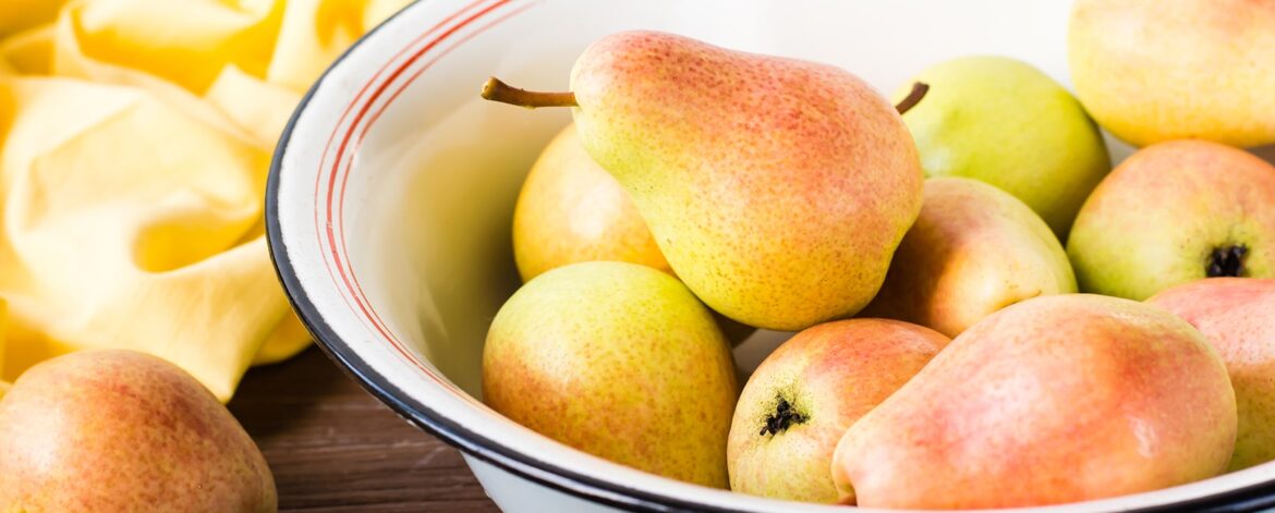 ripe-pears-in-an-enamel-plate-on-a-wooden-table-2023-11-27-04-56-29-utc-min